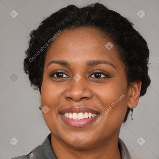 Joyful black adult female with short  brown hair and brown eyes