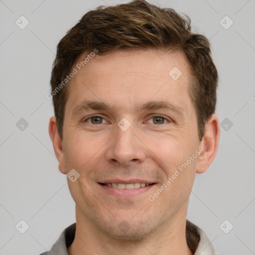 Joyful white adult male with short  brown hair and grey eyes