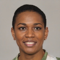Joyful black young-adult female with short  black hair and brown eyes