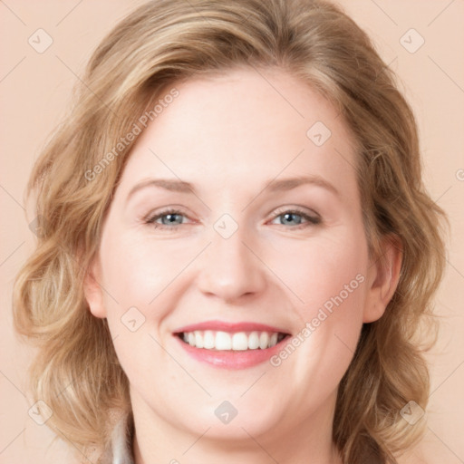 Joyful white young-adult female with long  brown hair and blue eyes