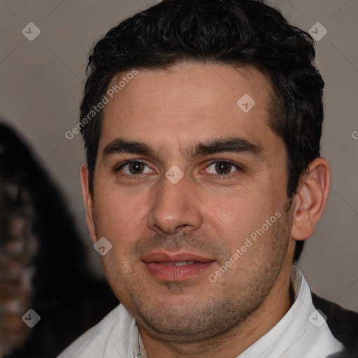 Joyful white adult male with short  black hair and brown eyes