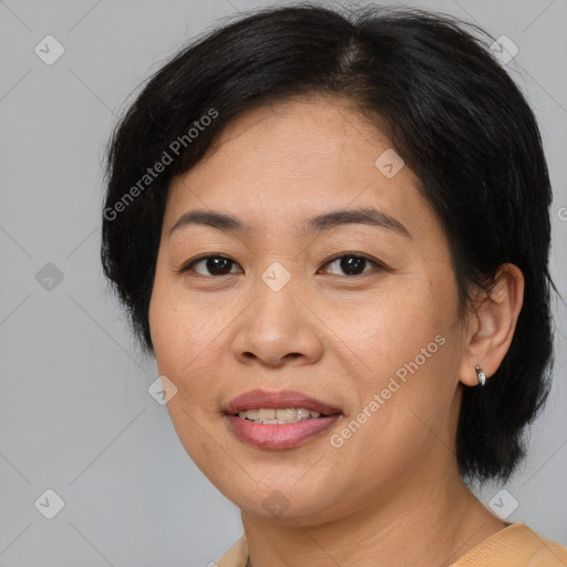 Joyful asian adult female with medium  brown hair and brown eyes