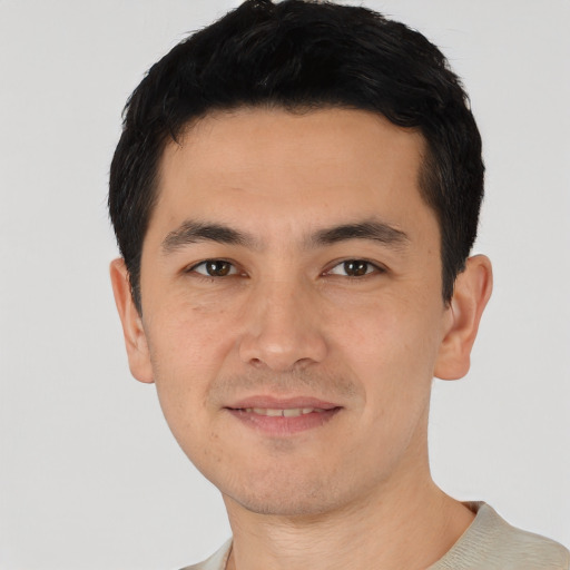 Joyful asian young-adult male with short  black hair and brown eyes
