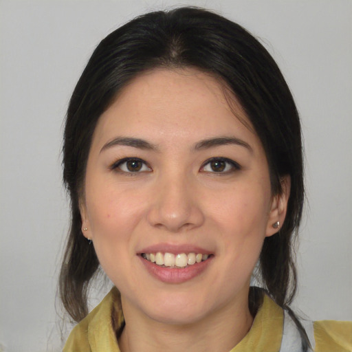 Joyful latino young-adult female with medium  brown hair and brown eyes