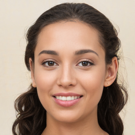 Joyful white young-adult female with long  brown hair and brown eyes