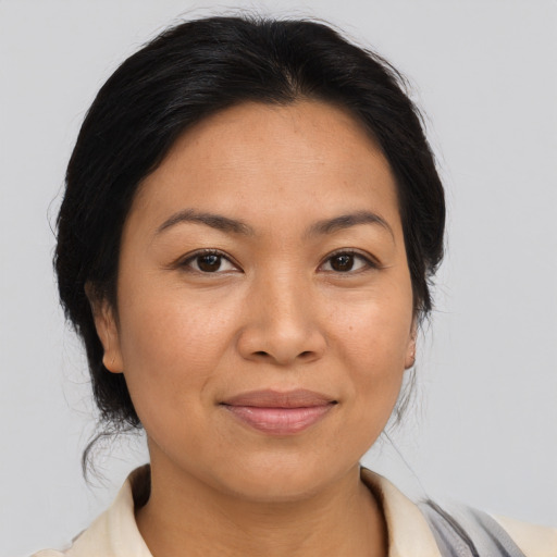 Joyful asian adult female with medium  brown hair and brown eyes