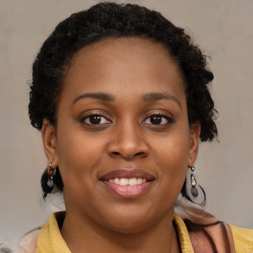Joyful black young-adult female with medium  brown hair and brown eyes