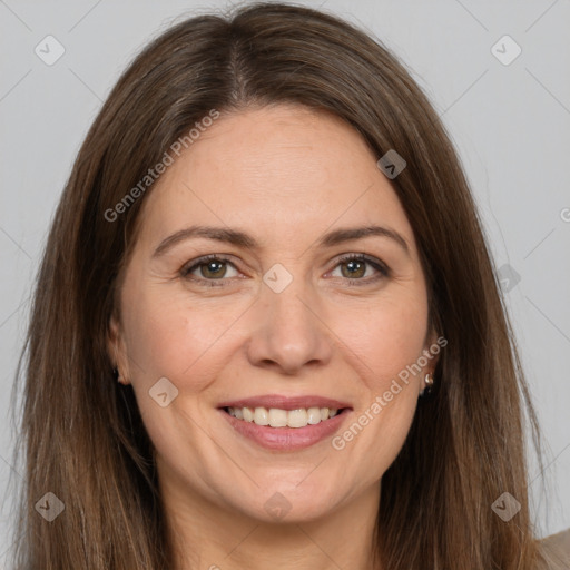 Joyful white adult female with long  brown hair and brown eyes