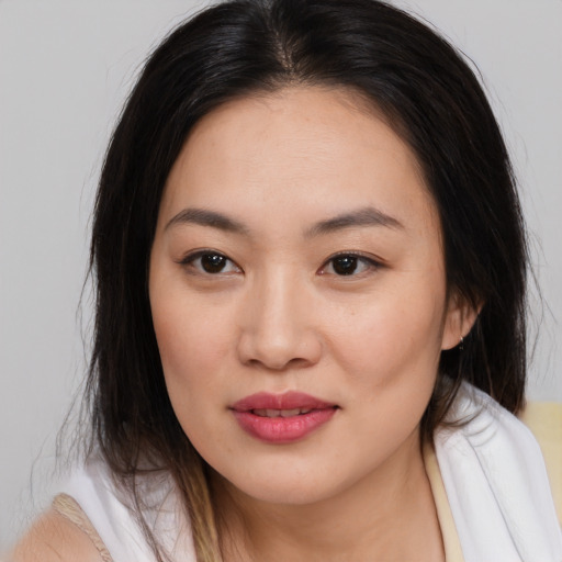 Joyful asian young-adult female with medium  brown hair and brown eyes