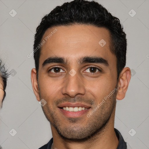 Joyful latino young-adult male with short  black hair and brown eyes