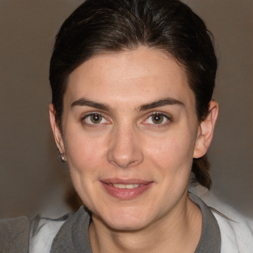 Joyful white adult female with medium  brown hair and brown eyes