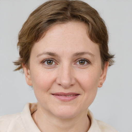 Joyful white young-adult female with short  brown hair and grey eyes