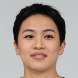 Joyful asian young-adult female with short  brown hair and brown eyes