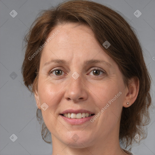 Joyful white adult female with medium  brown hair and grey eyes