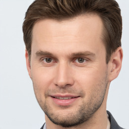 Joyful white young-adult male with short  brown hair and brown eyes