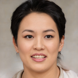 Joyful asian young-adult female with medium  black hair and brown eyes