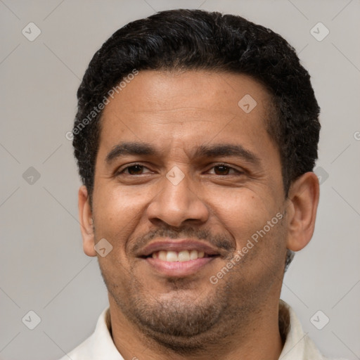 Joyful latino young-adult male with short  brown hair and brown eyes