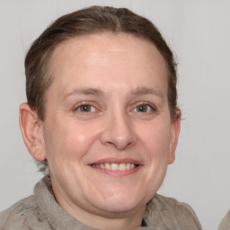 Joyful white adult female with short  brown hair and grey eyes