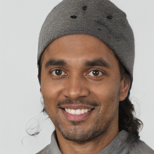 Joyful black young-adult male with short  black hair and brown eyes