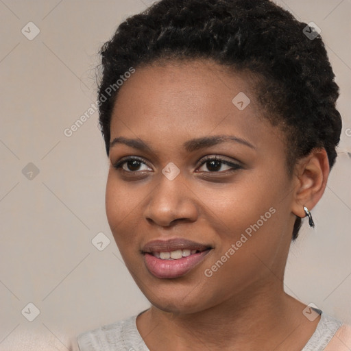 Joyful black young-adult female with short  black hair and brown eyes