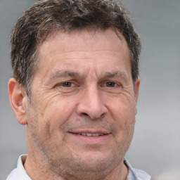 Joyful white middle-aged male with short  brown hair and brown eyes