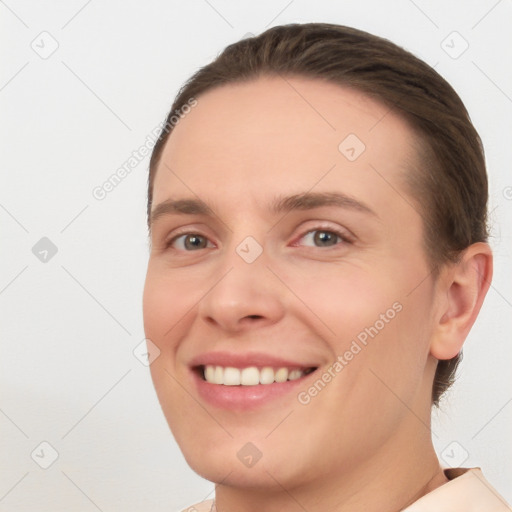 Joyful white young-adult female with short  brown hair and brown eyes