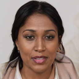 Joyful black adult female with medium  brown hair and brown eyes