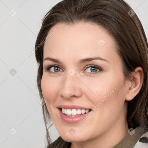 Joyful white young-adult female with medium  brown hair and grey eyes