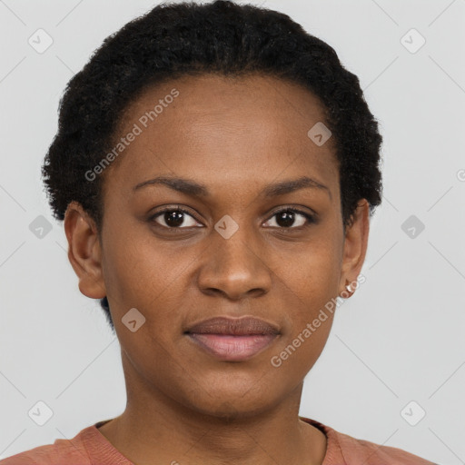 Joyful black young-adult female with short  black hair and brown eyes