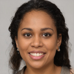 Joyful latino young-adult female with long  brown hair and brown eyes