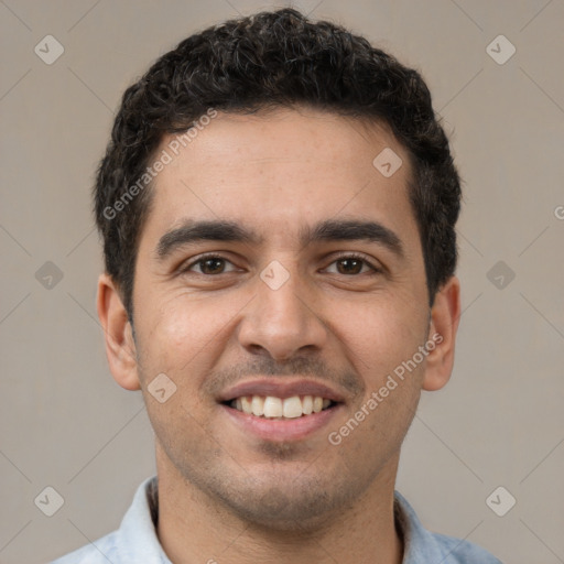 Joyful white young-adult male with short  black hair and brown eyes