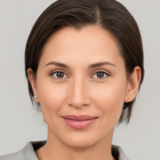 Joyful white young-adult female with medium  brown hair and brown eyes