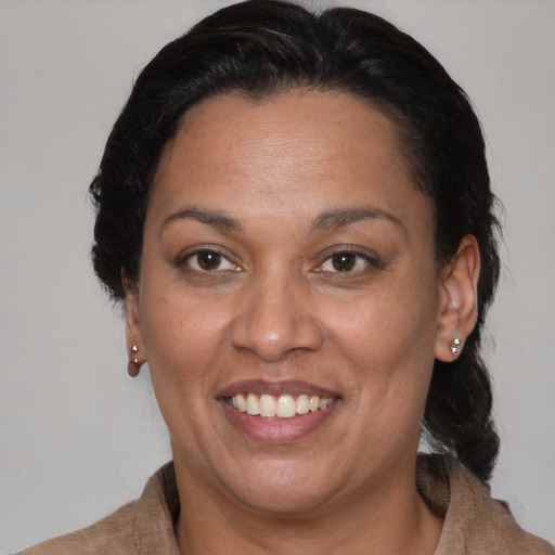 Joyful black adult female with medium  brown hair and brown eyes