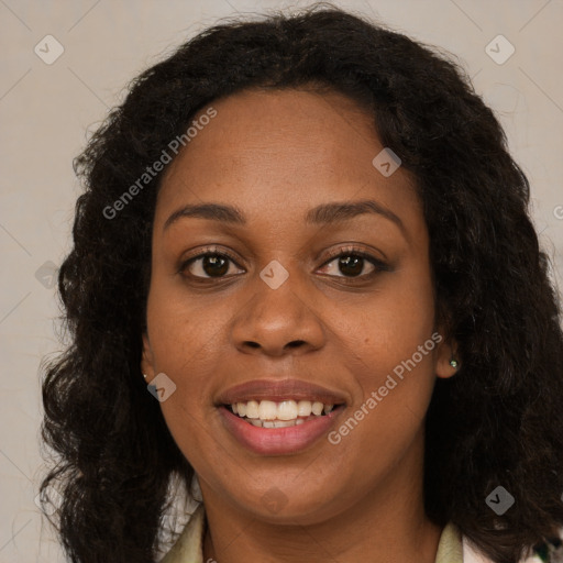 Joyful black young-adult female with long  brown hair and brown eyes