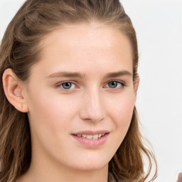 Joyful white young-adult female with long  brown hair and blue eyes