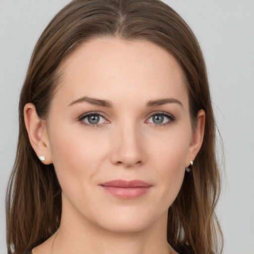 Joyful white young-adult female with long  brown hair and grey eyes