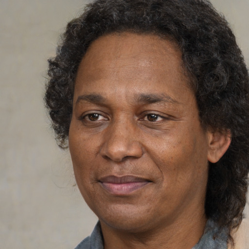 Joyful black adult male with medium  brown hair and brown eyes
