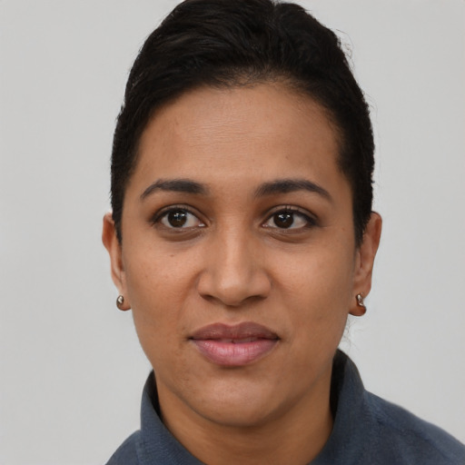 Joyful latino young-adult female with short  black hair and brown eyes