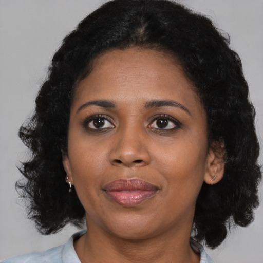 Joyful black young-adult female with medium  black hair and brown eyes