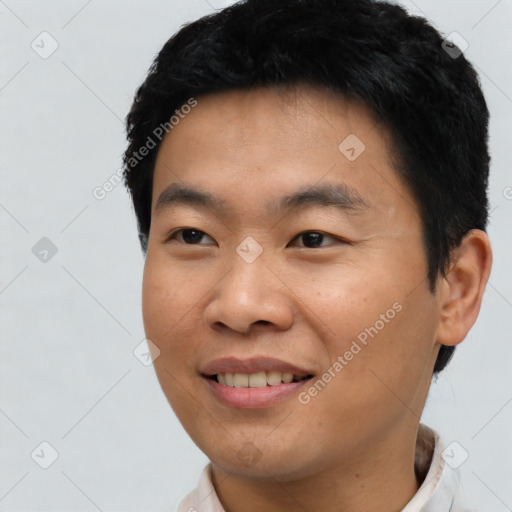 Joyful asian young-adult male with short  black hair and brown eyes