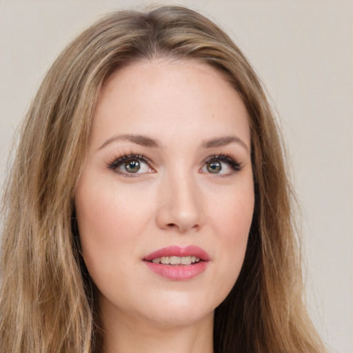 Joyful white young-adult female with long  brown hair and green eyes