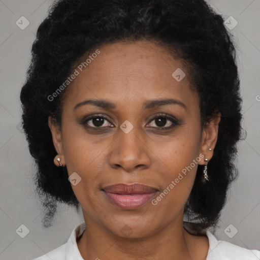 Joyful black adult female with medium  brown hair and brown eyes