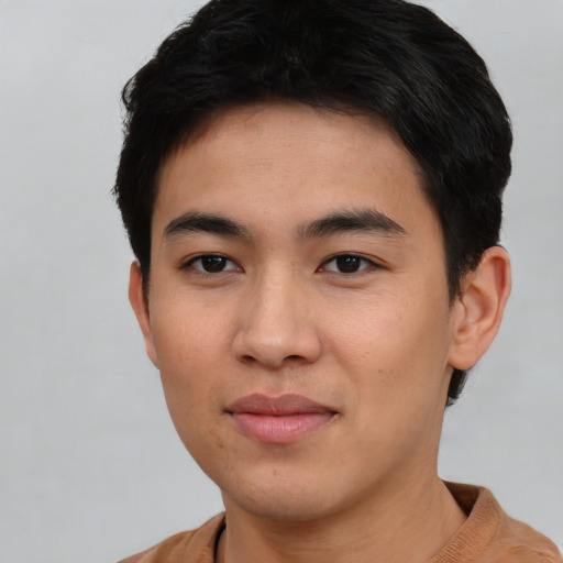 Joyful asian young-adult male with short  black hair and brown eyes