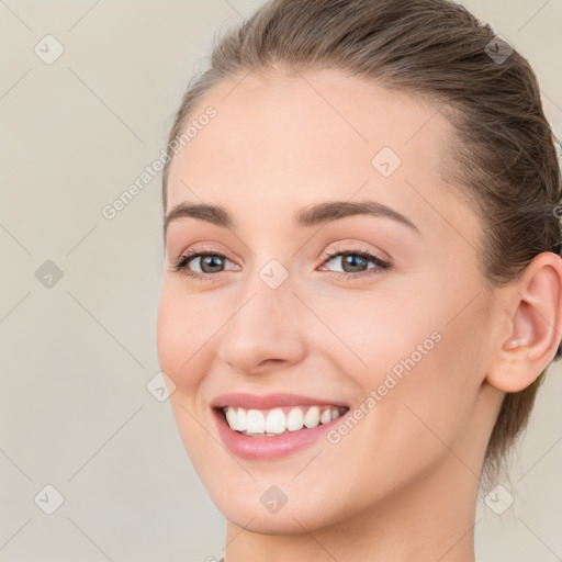 Joyful white young-adult female with long  brown hair and blue eyes