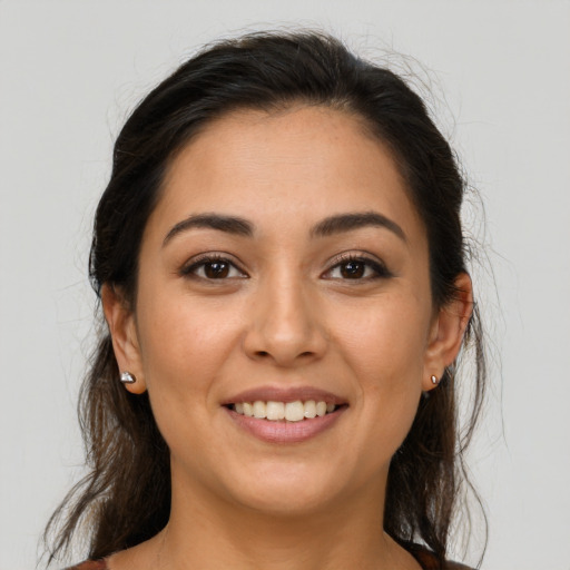 Joyful latino young-adult female with medium  brown hair and brown eyes