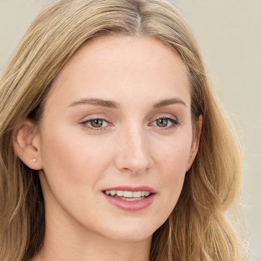 Joyful white young-adult female with long  brown hair and blue eyes