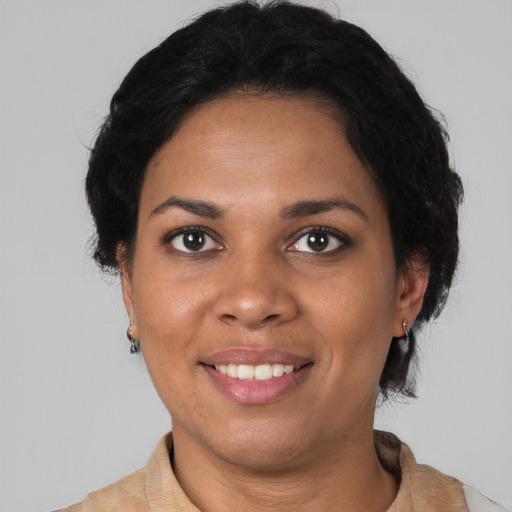 Joyful black young-adult female with medium  black hair and brown eyes