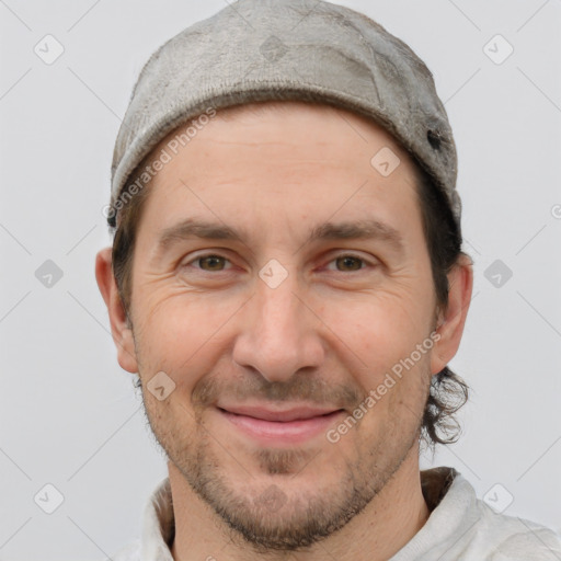 Joyful white adult male with short  brown hair and grey eyes