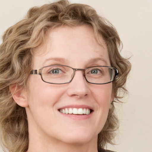 Joyful white adult female with medium  brown hair and blue eyes