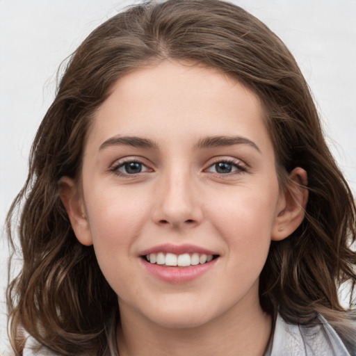 Joyful white young-adult female with medium  brown hair and grey eyes